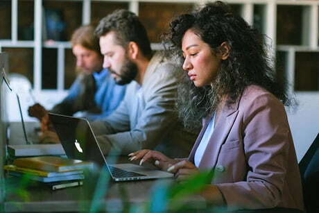 Professionals working on a complex OnBase to SharePoint Online migration challenges